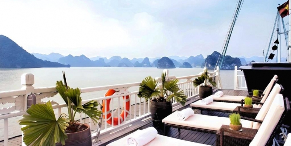 Admire Halong bay's beauty on sunbeds