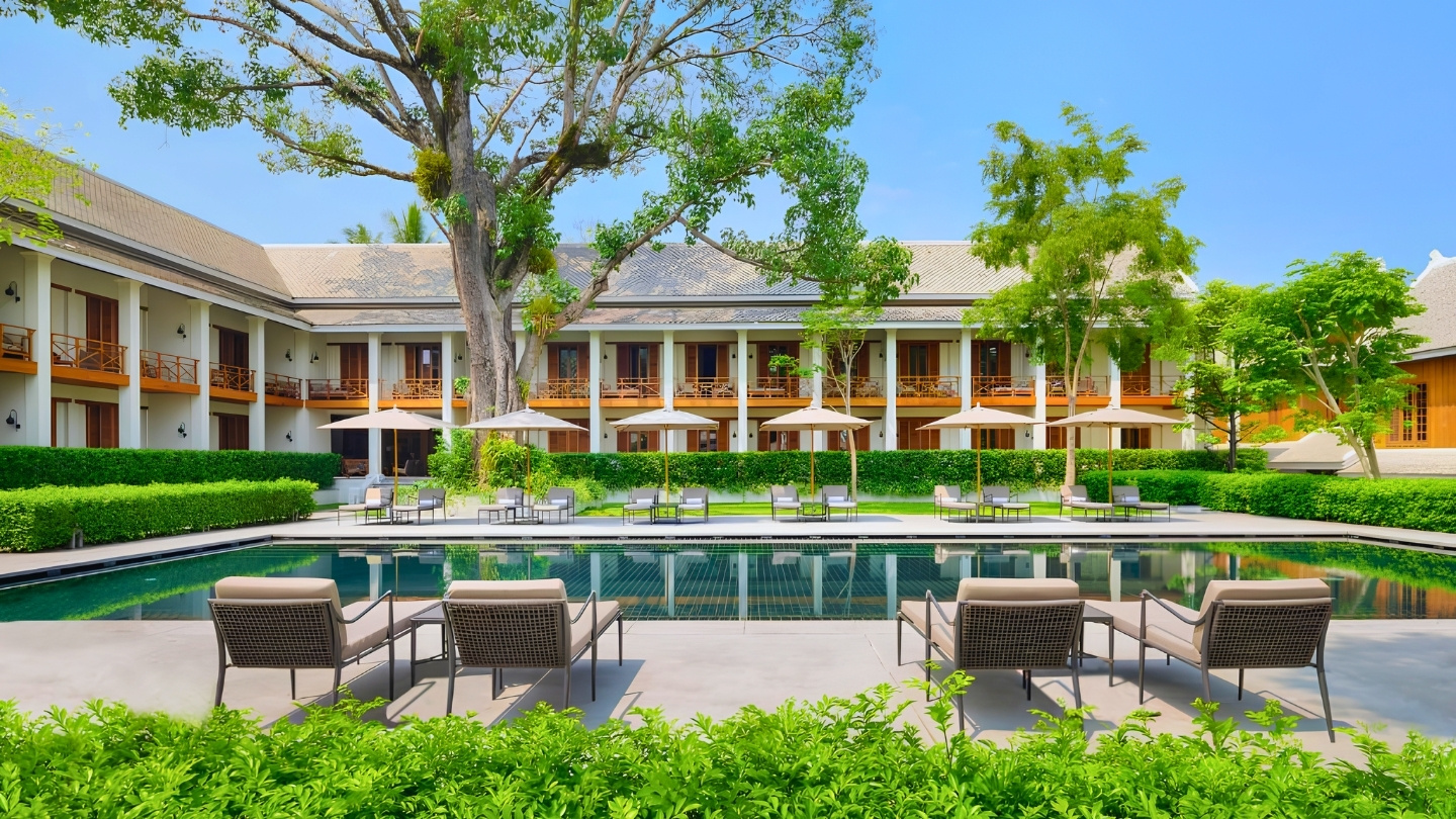 Swimming pool and tropical gardens at Avani+ Luang Prabang Hotel