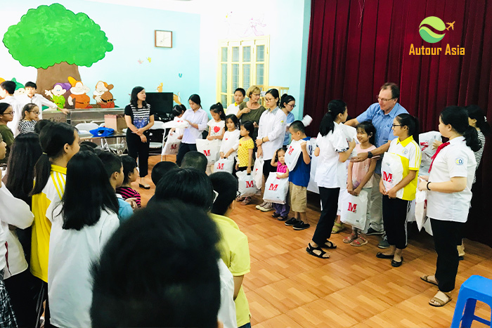 Mr Millet Claude and Mme Monique give gifts to children