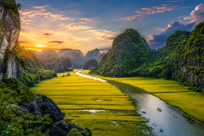 Traditional boat ride through the landscapes of Tam Coc