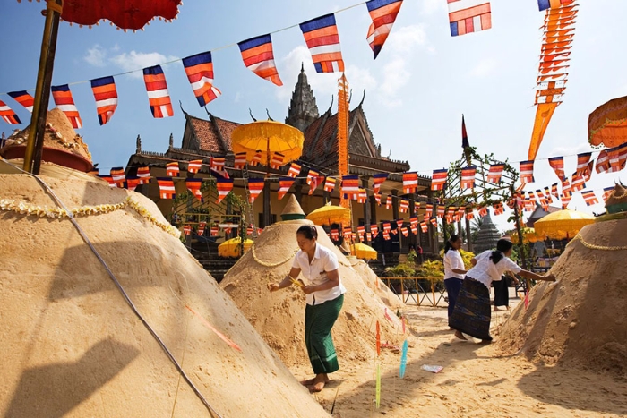 Building sand stupas, symbols of prosperity