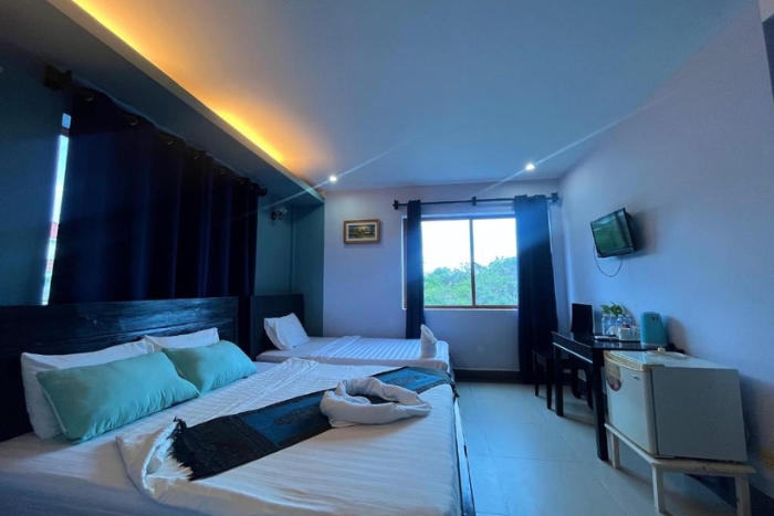 Elegance and comfort in a modern room at Au Paradis Bleu Hotel