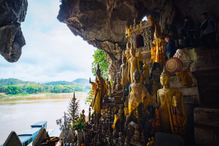 Explore the serene Pak Ou Caves, home to thousands of Buddha statues