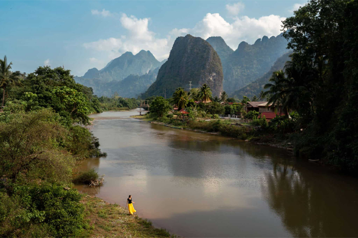 Vang Vieng offers solo travelers a mix of adventure and scenic landscapes
