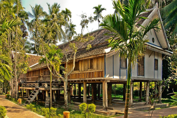 Admire traditional Lao wooden houses, showcasing the unique architectural heritage of northern Laos