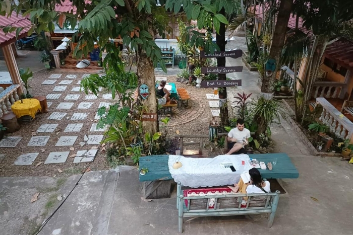 Tourists relax at Khamphouy Guesthouse