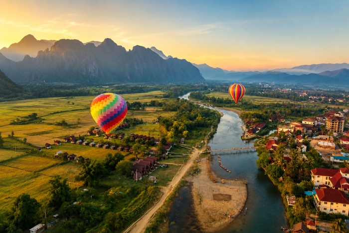 Panoramic view of Vang Vieng from a hot air balloon at sunrise