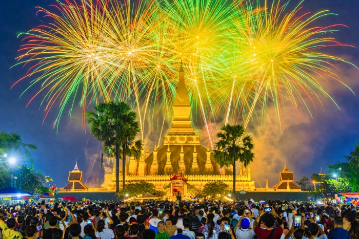 Pha That Luang illuminated under the fireworks of the festivals in Laos in April