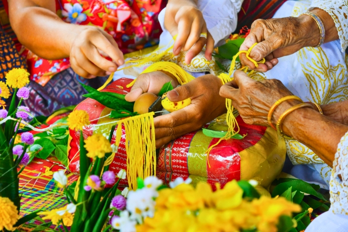 What to do in Laos in April ? Tie a thread, share a wish during the Baci ceremony in Laos