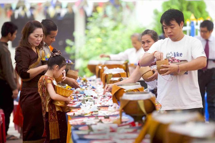 Laotians visit the temple during the Boun Ho Khao Padabdin Festival