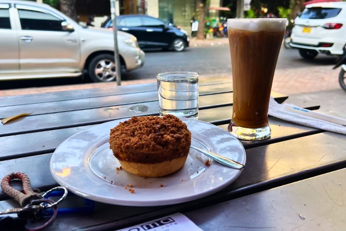 Lao iced coffee with pastry at Joma Café - a tasty break on my Vientiane food tour