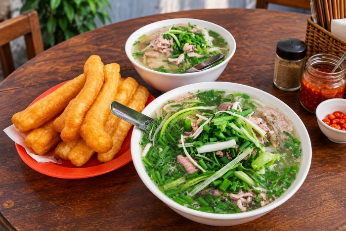 Enjoying phở b&ograve; in Hanoi during a 2-week Thailand Vietnam tour