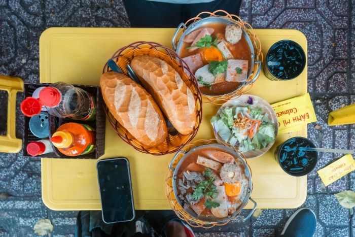 Discovering street food is an essential part of a Thailand Vietnam tour 7 days