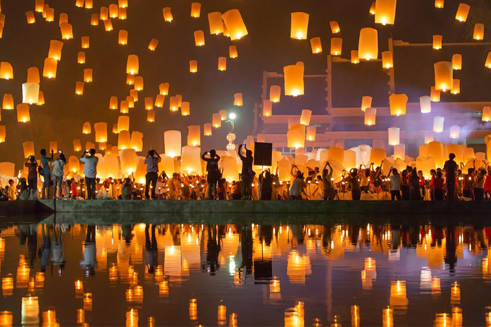 Locals releasing sky lanterns during Yi Peng Festival in Chiang Mai