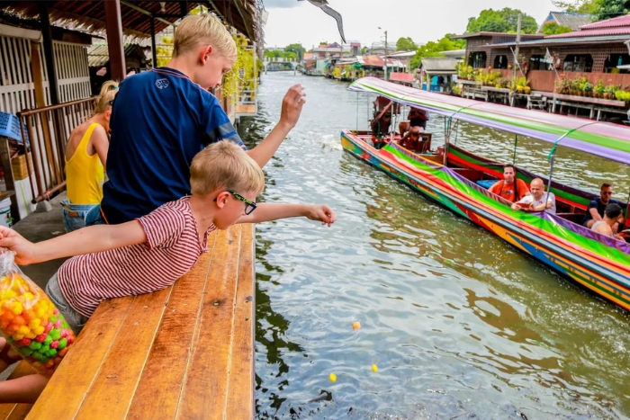 Feeding the fish, a gesture believed to bring good luck