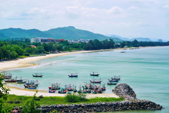 Fishing boats rest along Hua Hin coastal bay