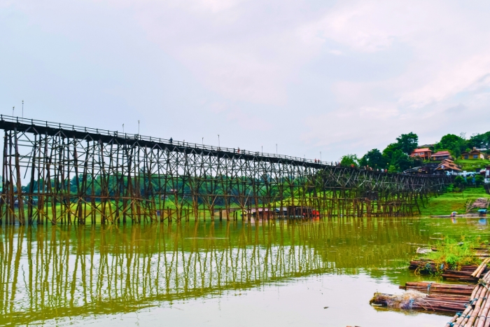Traditional Mon Bridge stands above lake in Sangkhla Buri