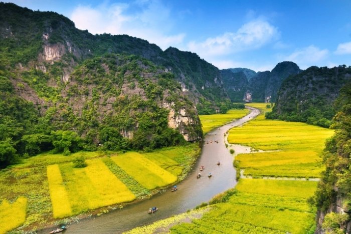 Cruising through Tam Coc’s rice fields by sampan