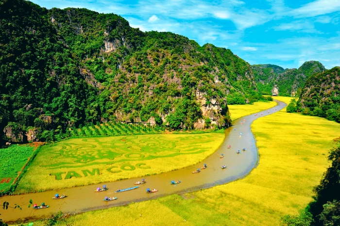 Boats glide slowly through Ninh Binh’s green valleys