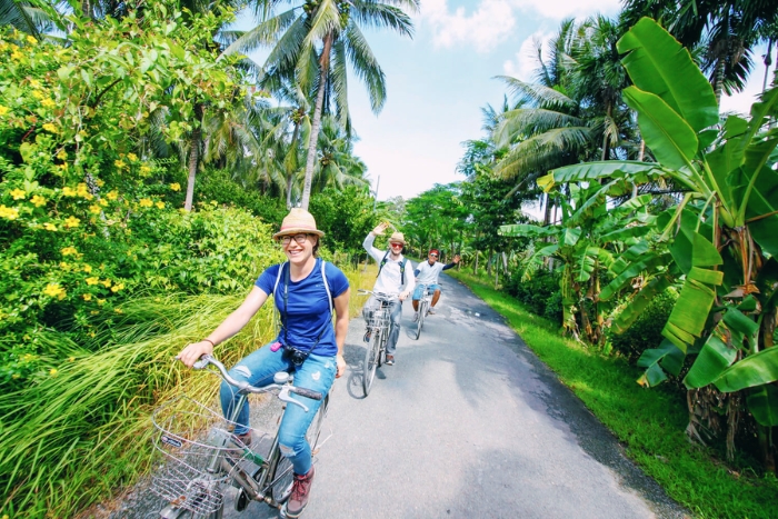 Exploring lush coconut groves by bicycle in the Delta