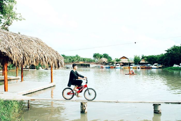 Cycling on the small bamboo bridge in My Khanh village