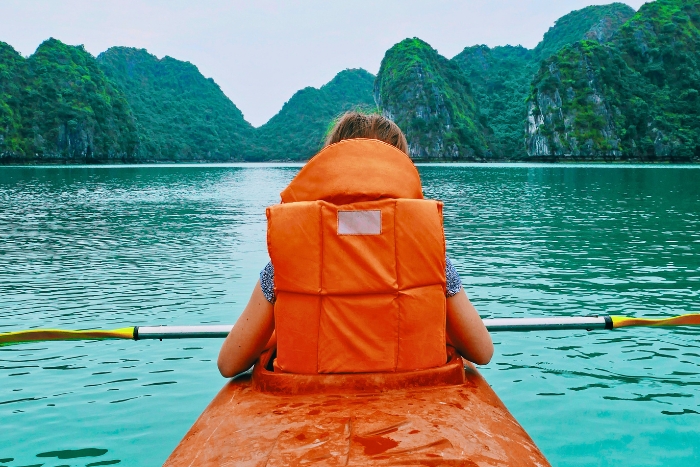 A peaceful kayak journey between towering green karst formations