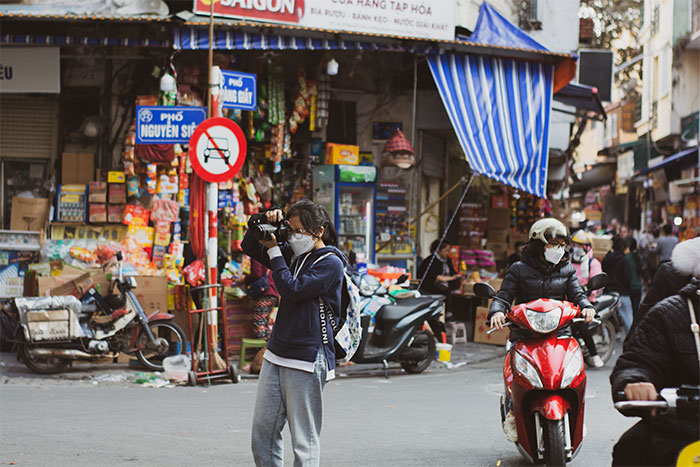 A photographer on the street of Hanoi's old quarter