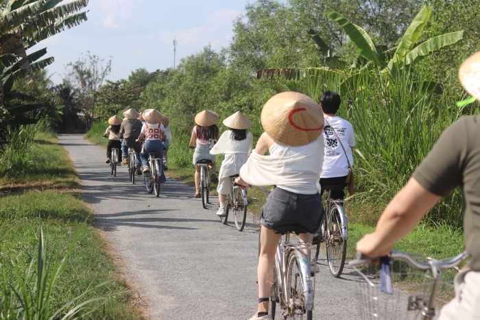 Cycling through the lush green tice fields of Southern Vietnam