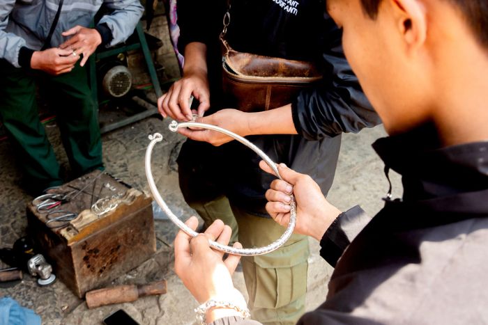 Observe the artisans crafting silver jewelry in Lao Xa Village