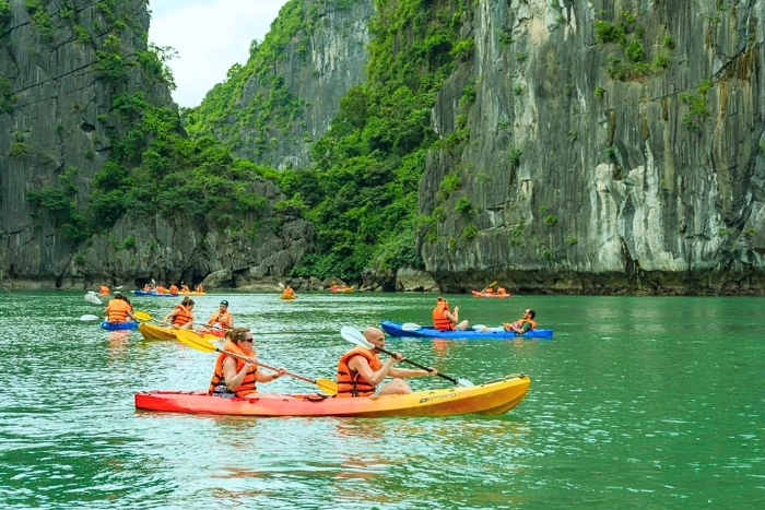 Gliding over the summer waters of Halong Bay by kayak