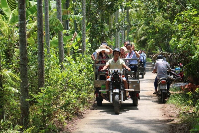 Crossing rice fields and plains by xe loi - a local vehicle in Ben Tre