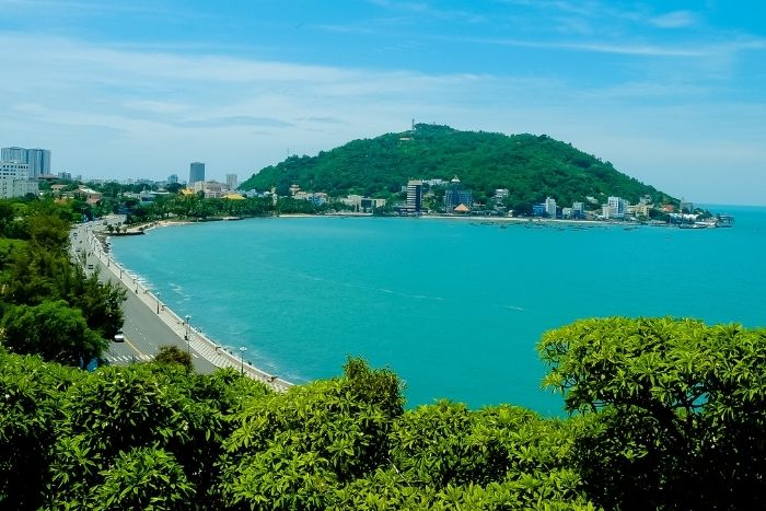 Relax on Vung Tau Beach, known for its soft sand and clear blue waters