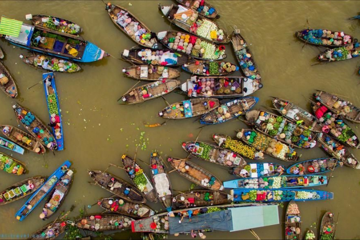 Experience the traditional floating market in the Mekong Delta