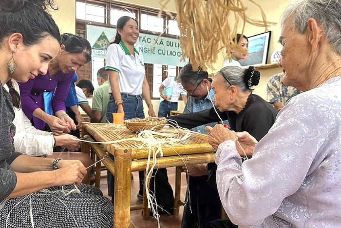 Tourists are excited to participate in experiencing traditional work with skilled artisans in the village