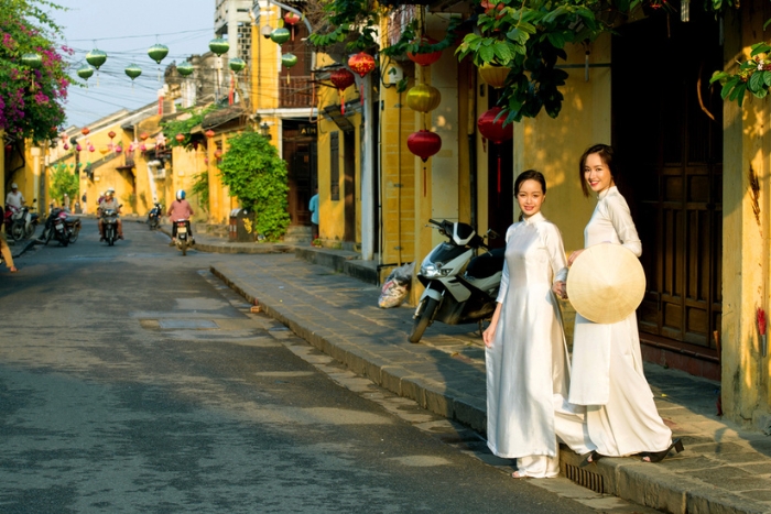 Vietnamese charm in áo dài in the narrow streets of Hoi An