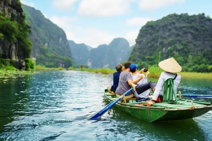 Take a boat ride through Tam Coc