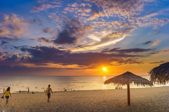Soft waves and warm skies at Nhat Le Beach