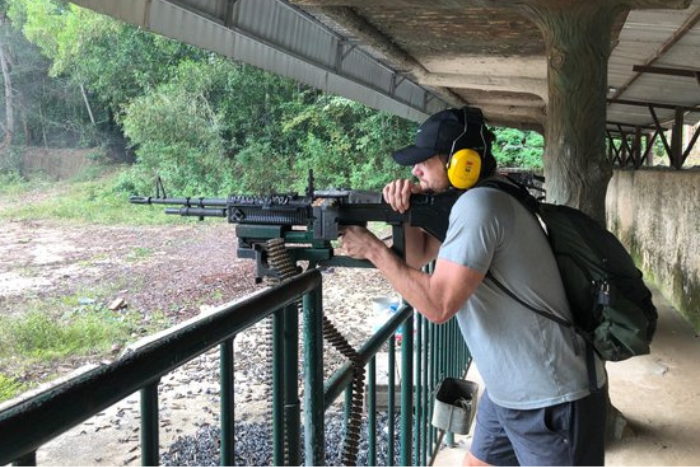 A tourist takes part in a shooting sport at the Cu Chi Tunnels