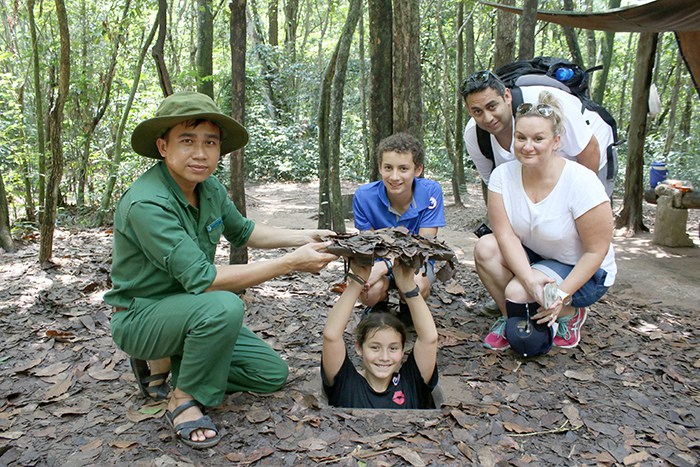 Visitors experience war simulation activities at the Cu Chi Tunnels