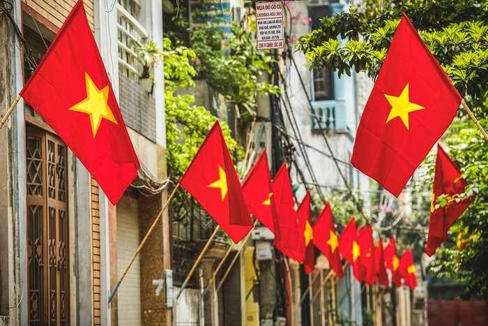 The streets on April 30 are adorned with red banners and flags