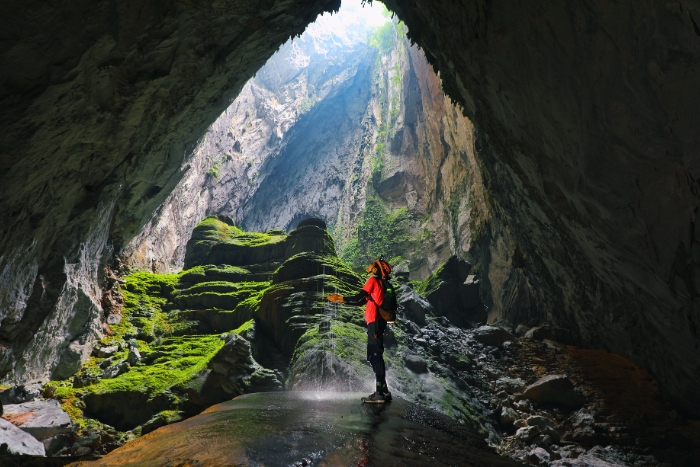 Sunlight pours into Phong Nha caves through towering limestone
